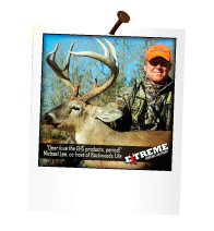 hunter next to a deer with large antlers