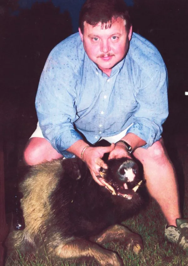Man holding dead hogs head